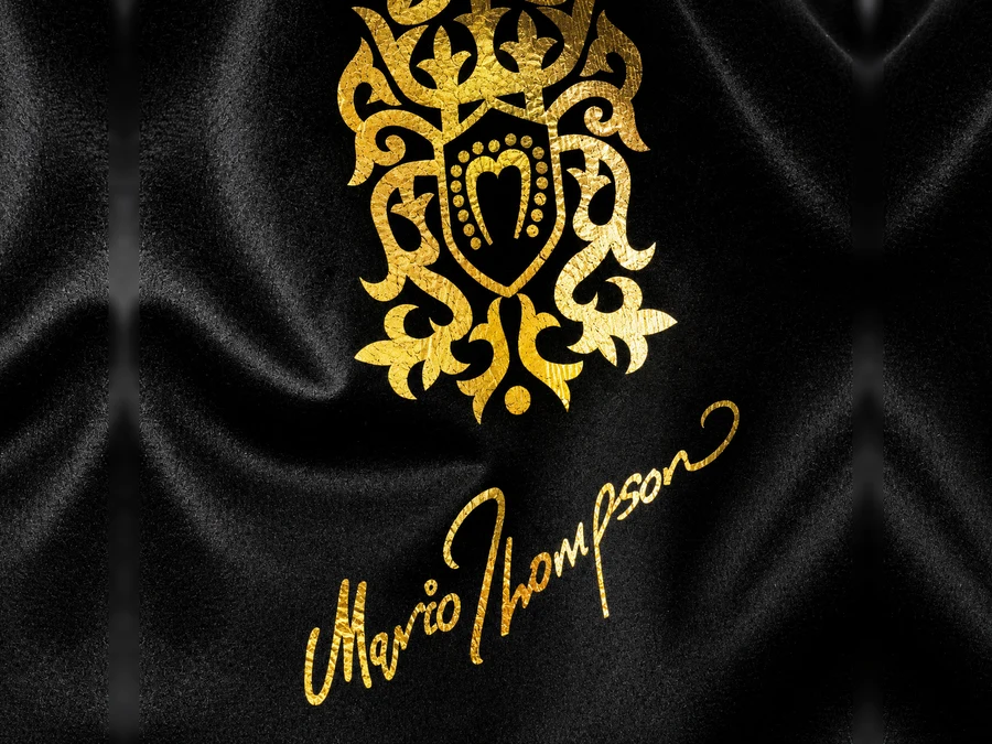 Gold foil-stamped monogram pressed into navy velvet